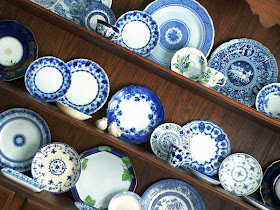 flow blue and white china in hutch