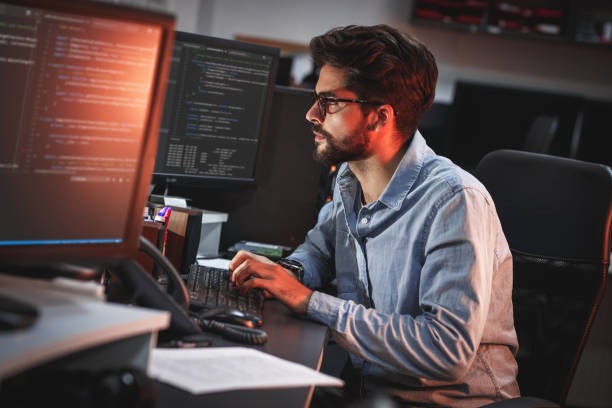 Male programmer working on computer.