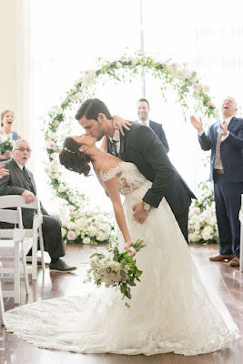 groom dipping bride down the aisle