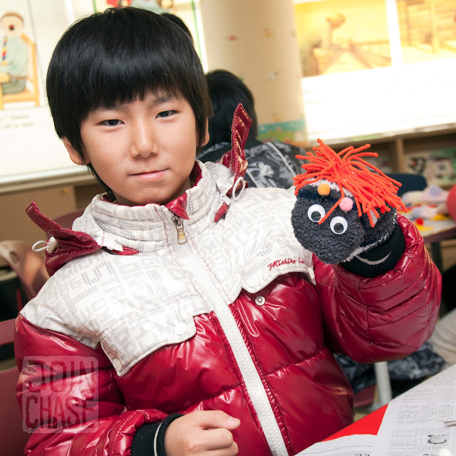 A student making a sock puppet during Winter English Camp at Bibong Elementary in Ochang, South Korea.