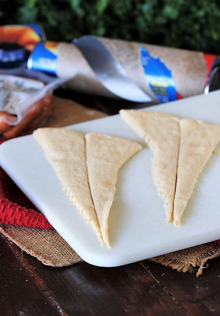 Preparing Crescent Roll Triangles to Make Pigs In a Blanket With the Works Image