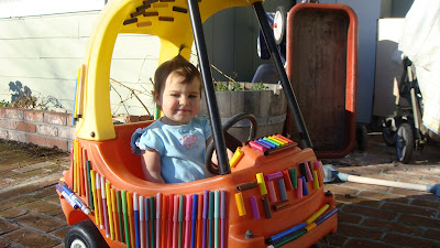 Girl in her toy pen car