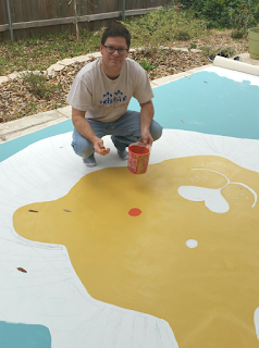 Artist, David Borden, painting the stage backdrop for MossFest 2016.