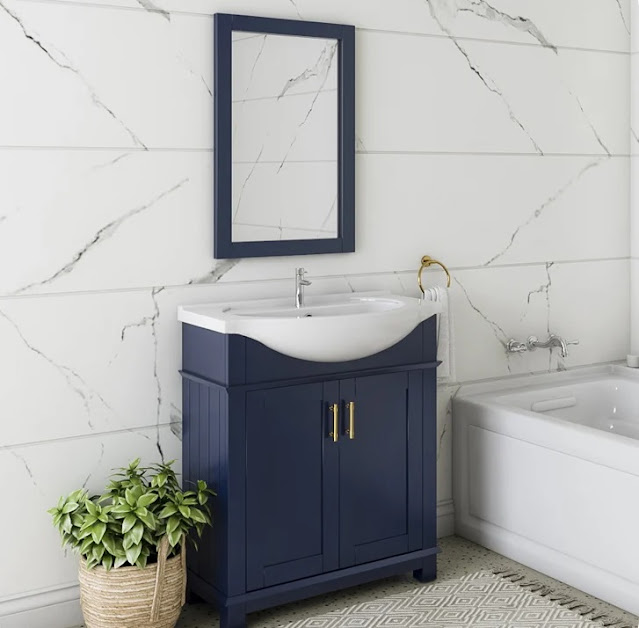 Marble walled bathroom with a blue vanity.