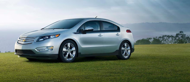 Front 3/4 view of silver 2012 Chevrolet Volt parked on a bluff overlooking the sea