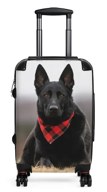 Travel Suitcase With Solid Black German Shepherd Wearing a Red Romal Lying on the Grass