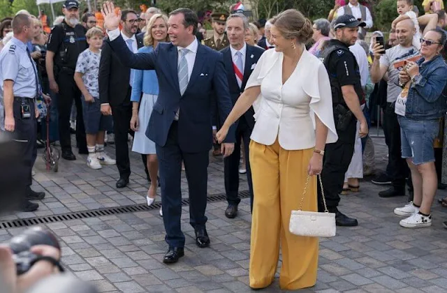 Princess Stephanie wore a white cape blouse, and yellow wide-leg trousers. Hereditary Grand Duchess Stephanie