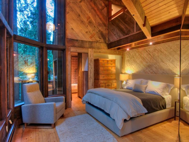 Photo of bedroom inside of tree house in the forest