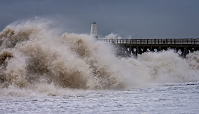 Photo of giant waves crashing onto the shore at Maryport during Storm Erik