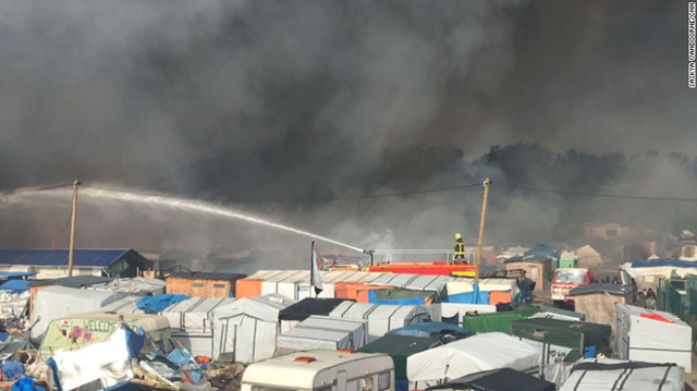 Firefighters struggle to control the dozens of fires tearing through the refugee camp in Calais known as 'the Jungle', 26 October 2016. Photo: Saskya Vandoorne / CNN