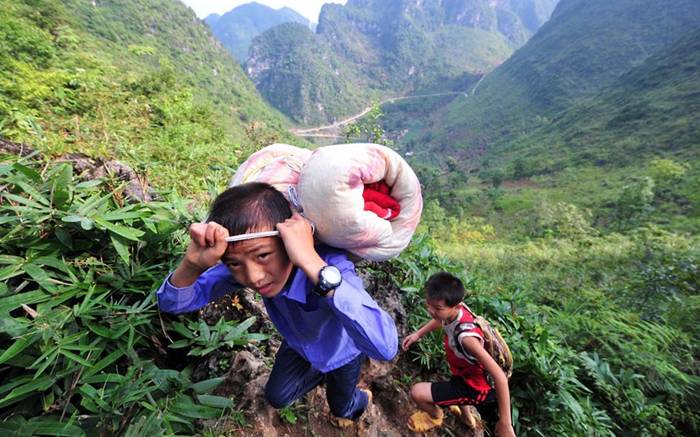 Students carry their belongings
                                  as they trek back to school from home
                                  on a rugged mountain path in Dahua Yao
                                  Autonomous County, southwest China's
                                  Guangxi Zhuang Autonomous Region. As
                                  the children live in mountains far
                                  away from the village school, most of
                                  them stay there during the school year
                                  and return home for the summer and
                                  other holidays.Picture:
                                  KeystoneUSA-ZUMA / Rex Features