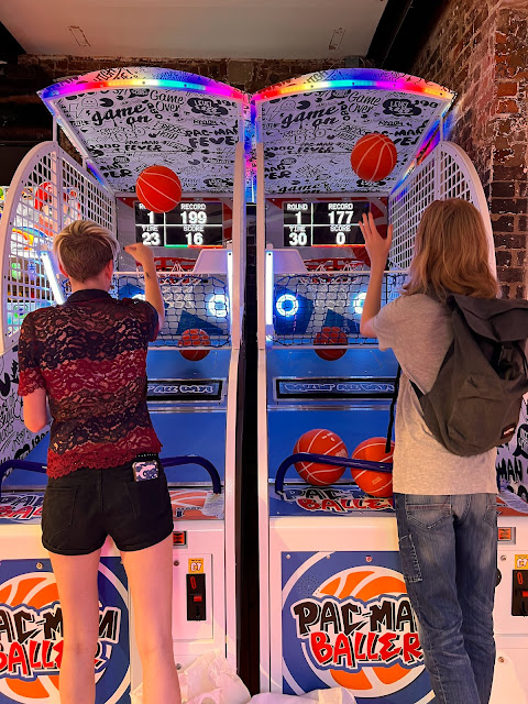 people playing arcade basketball game