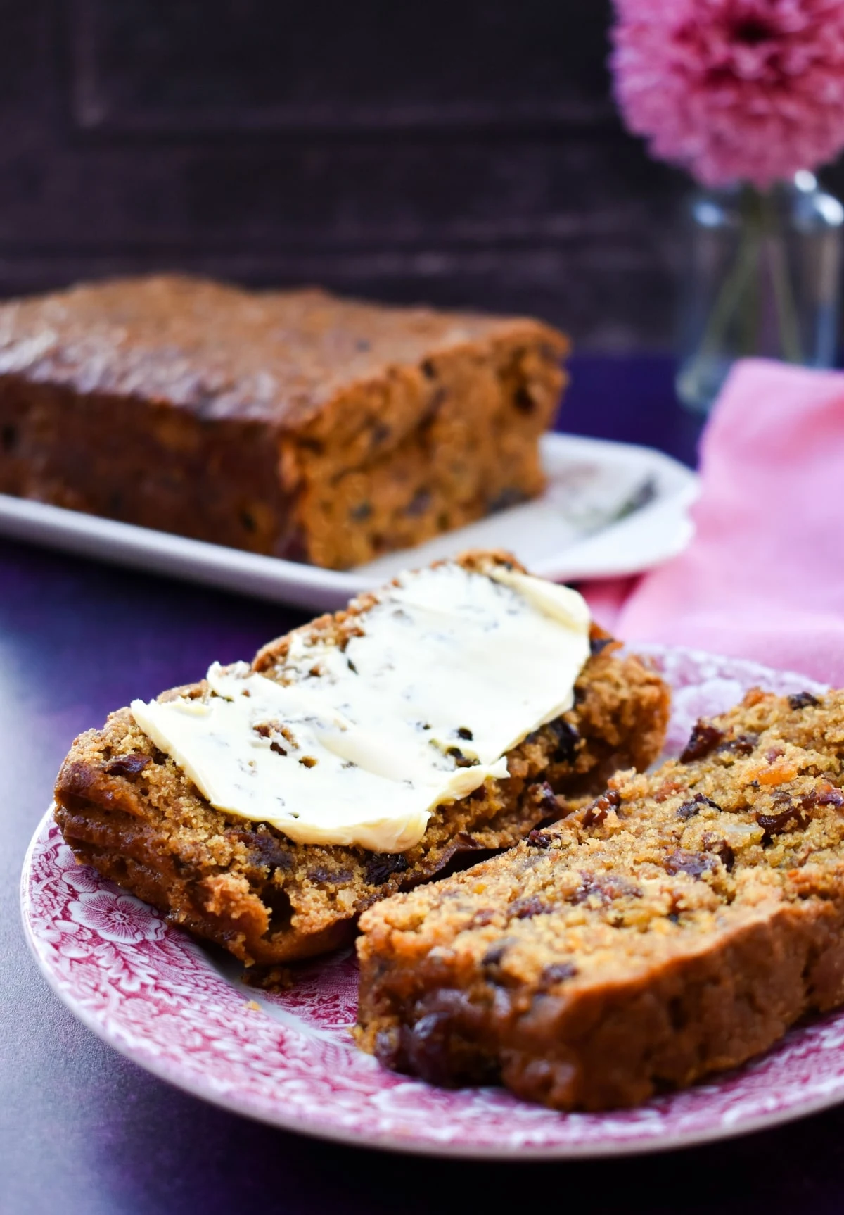 Dairy-free fruit loaf cake, sliced and spread with dairy-free butter.