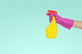 Hand holding a cleaning spray