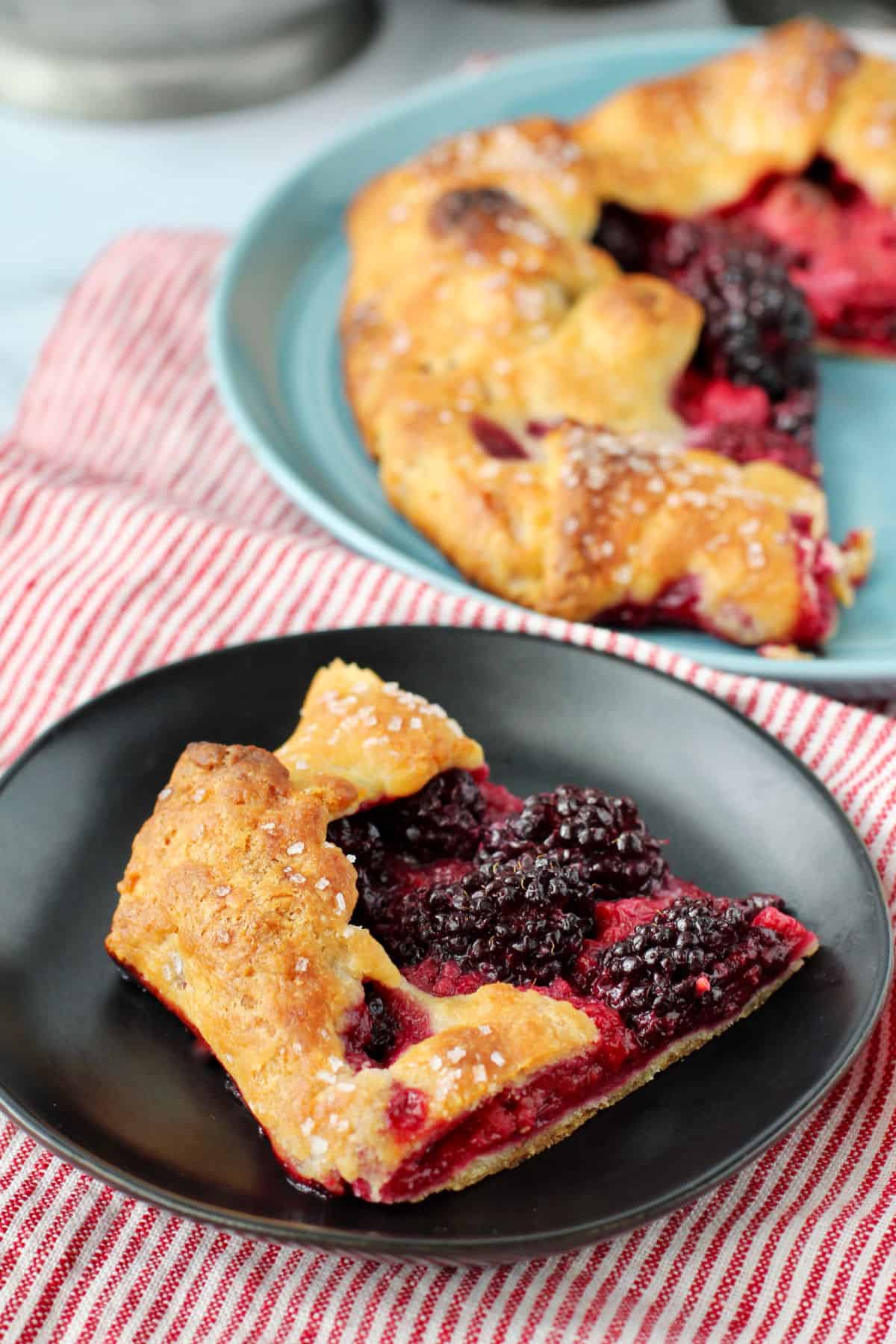 Berry Galette on a black plate.