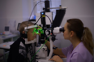 A photo of an eye exam taking place.