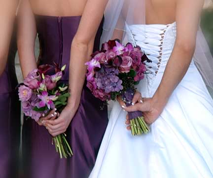 Hand tied bridal bouquet of purple tulips and calla lilies with a few green