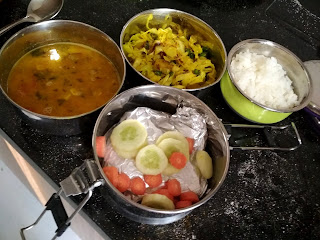 rotis, salad, cabbage and peas sabji, dal and rice