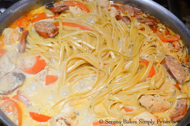 One Pot Cajun Chicken Pasta in a stainless steel pot with lid removed.