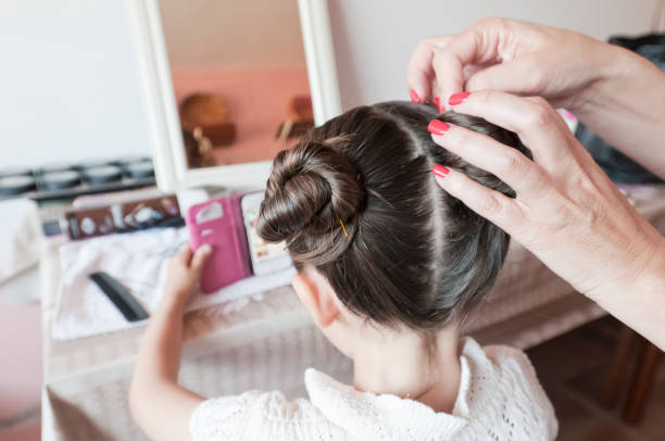 woman styling little girl's hair