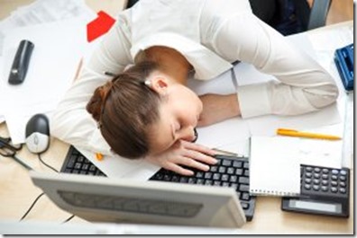 Woman-asleep-on-laptop-at-desk