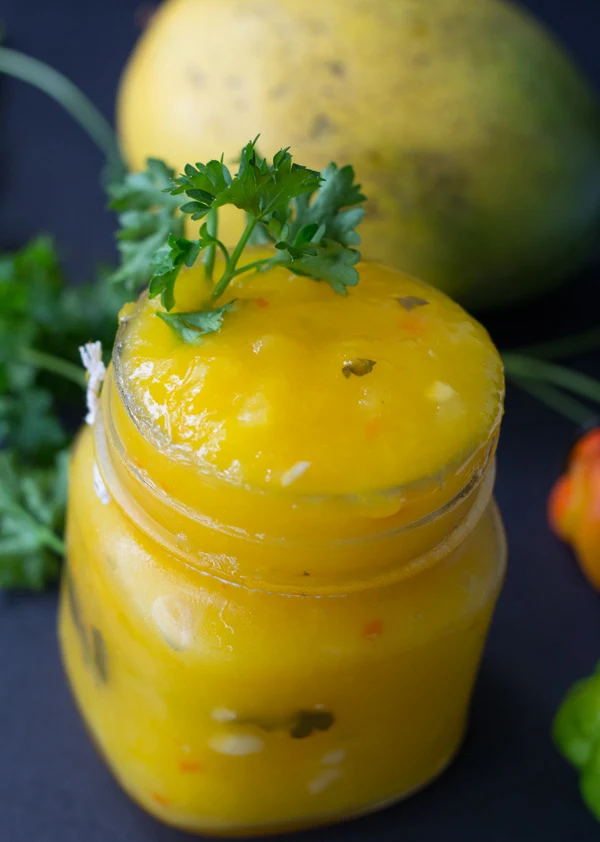 A top view of a bottle of completed Guyanese mango sour.