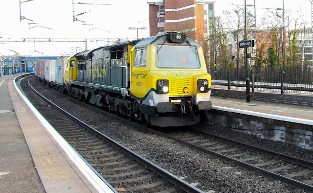 freightliner freight uk diesel locomotive class 70007 passes through wolverton station with a train of containers in march 2013 heading north 2012