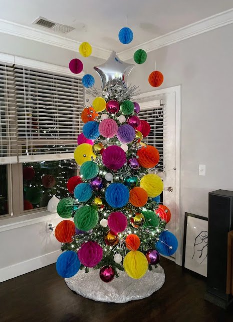 Birthday tree decorated with colorful paper fan balls.