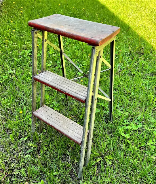 Photo of a rustic wood & metal stepladder.