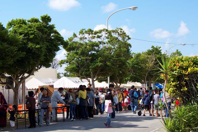 crowd of festival goers being served tuna sashimi