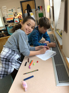 Students using cuisinaire rods to explore fractions. 