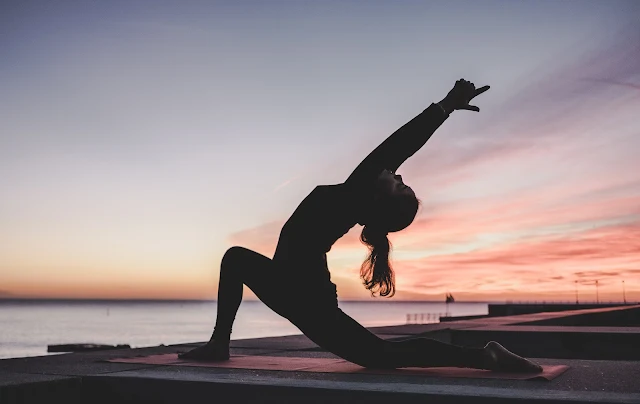 women stretching on beach