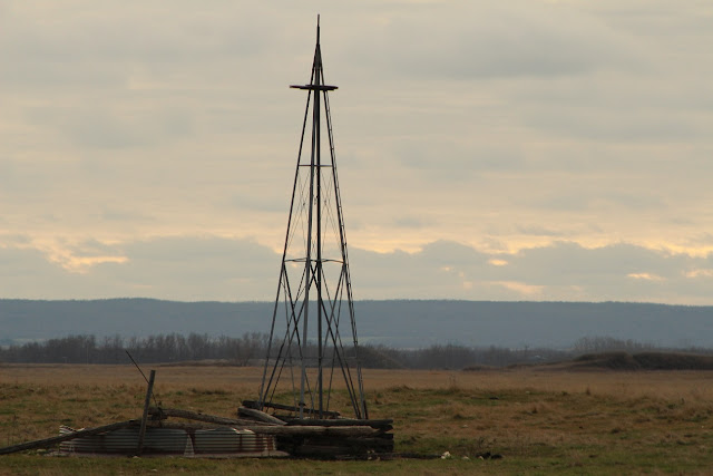 Old well in grassy field