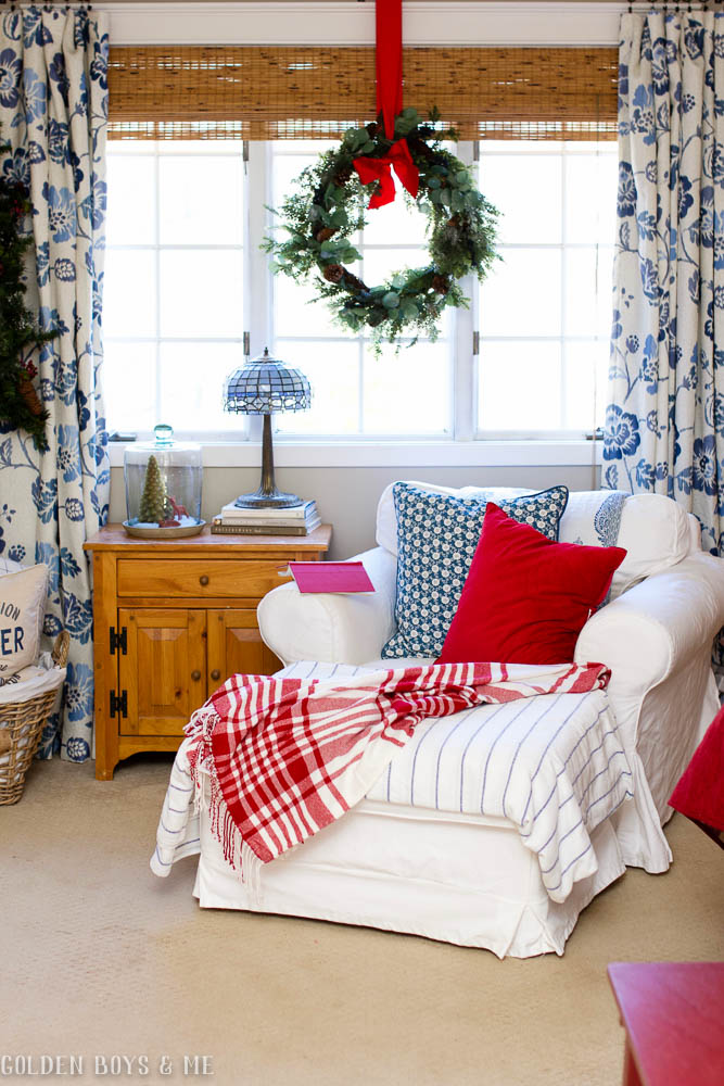 Cozy reading spot in Christmas master bedroom with Ikea slipcovered Ektorp chair