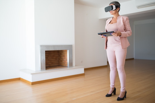 Woman using a VR helmet to have a virtual tour