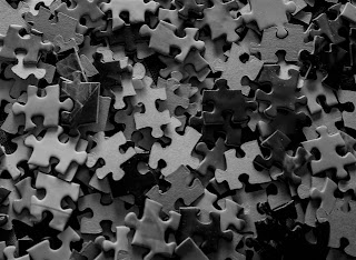 black and white pile of puzzle pieces