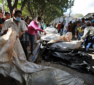 Honduran prison fire: searching through body bags