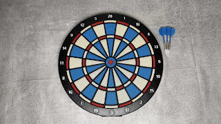 The dartboard and darts in the packaging