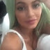 Tyga leans on Kylie Jenner's cleavage in new racy Snapchat video