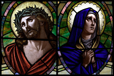 Stained glass window portraits of Jesus crowned with thorns and the Virgin Mary Praying