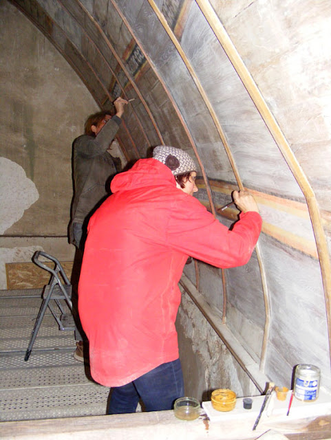 Wall paintings conservators working on the vaulted ceiling of a medieval chapel, Indre et Loire, France. Photographed by Susan Walter. Tour the Loire Valley with a classic car and a private guide.