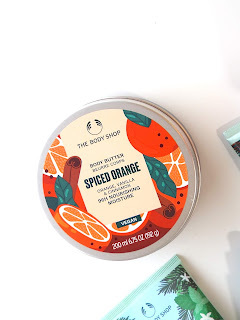 The Body Shop Spiced Orange Body Butter, in orange slice print tin.