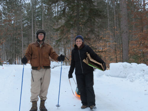 two people walking in snow