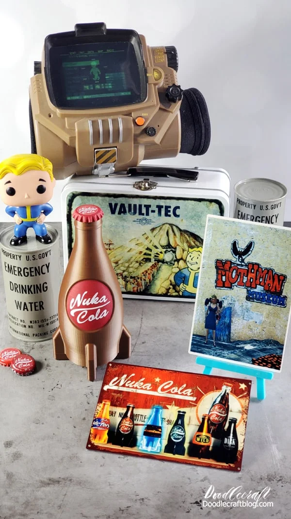 Fallout themed merchandise, Spirit Halloween Pip Boy, Funko Pop Vault Boy, Emergency drinking water, Nuka Cola Rocket Bottle, Vault-Tec Lunchbox, Mothman Museum metal sublimation print and bottle caps.