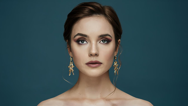 An image of a woman confidently applying setting spray to her makeup, symbolizing the power and assurance provided by tips for makeup longevity.