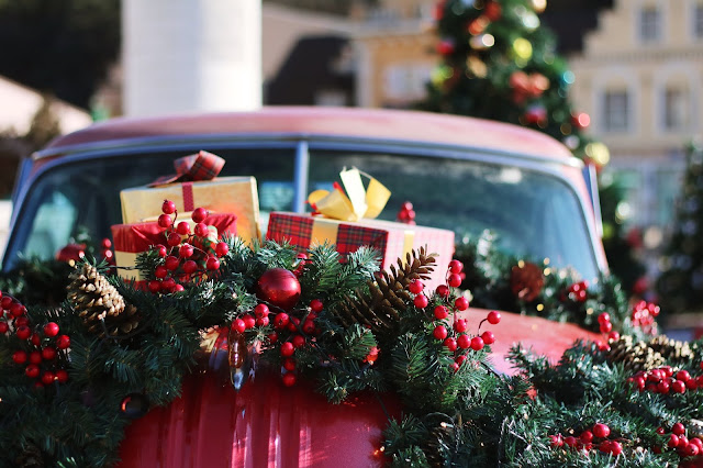 car decorated with Christmas wreath Photo by Honey Fangs on Unsplash