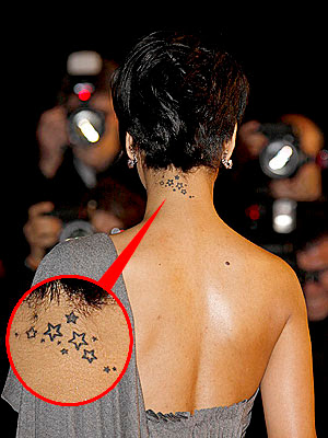 Upper back and neck tattoo of a swallow