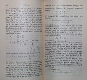 An open book of printed text and equations.