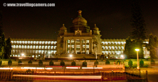Night Photographs of Vidhan Saudha @ Banglore, Karnataka : Posted by VJ SHARMA on www.travellingcamera.com : Before going to Banglore I had heard a lot about Vidhan Saudha... Yes, you read it right : 'Saudha'... In North India Legistrative Assembly is called as Vidhan Sabha and this was the first change I noticed after reaching there...The Vidhana Soudha is located in Bangalore (Bengaluru) and its a seat of the state legislature of Karnataka. Vidhan Saudha has a very attractive building and the architecture has Indo Saracenic and Dravidian styles... Vidhan Saudha wa constructed in 1956 which I know from Wikipedia..Before going to Banglore I had heard a lot about Vidhan Saudha... Yes, you read it right : 'Saudha'... In North India Legistrative Assembly is called as Vidhan Sabha and this was the first change I noticed after reaching there...The Vidhana Soudha is located in Bangalore (Bengaluru) and its a seat of the state legislature of Karnataka. Vidhan Saudha has a very attractive building and the architecture has Indo Saracenic and Dravidian styles... Vidhan Saudha wa constructed in 1956 which I know from Wikipedia..I wanted to visit this place during day time but always plans changed and didn't get time to come here.. On the last day of my trip my friend brought me here at 1:00 am and I had no tripod... Some security people were also roaming around there and I didn't want to take any risk there.. So most of the shots were clicked within 5 minutes of duration by stopping our car in front of the building... But finally I got something and of-course, something is better than nothing :) shaky photograph of main entry of Vidhan Saudha in Banglore... A volvo bus which goes to airport was just crossing....While we were driving back for home, I saw another beautiful building and it was Banglore Post Office building... There is a red light near to this building and we were waiting for it to turn green...Black and White photographs hide all the noise due to high ISO :)