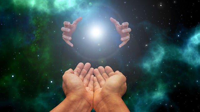 One big hand tries to touch one small hand in spiritual ways